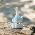 Ceramic Rotating Garlic Duck Figurine – Cute Blue Gradient Goose Desk Toy on Light Blue Base