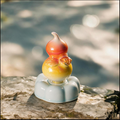 Iridescent Ceramic Rotating Gourd Figurine – Orange & Yellow Rose Wu Lou on Light Blue Base
